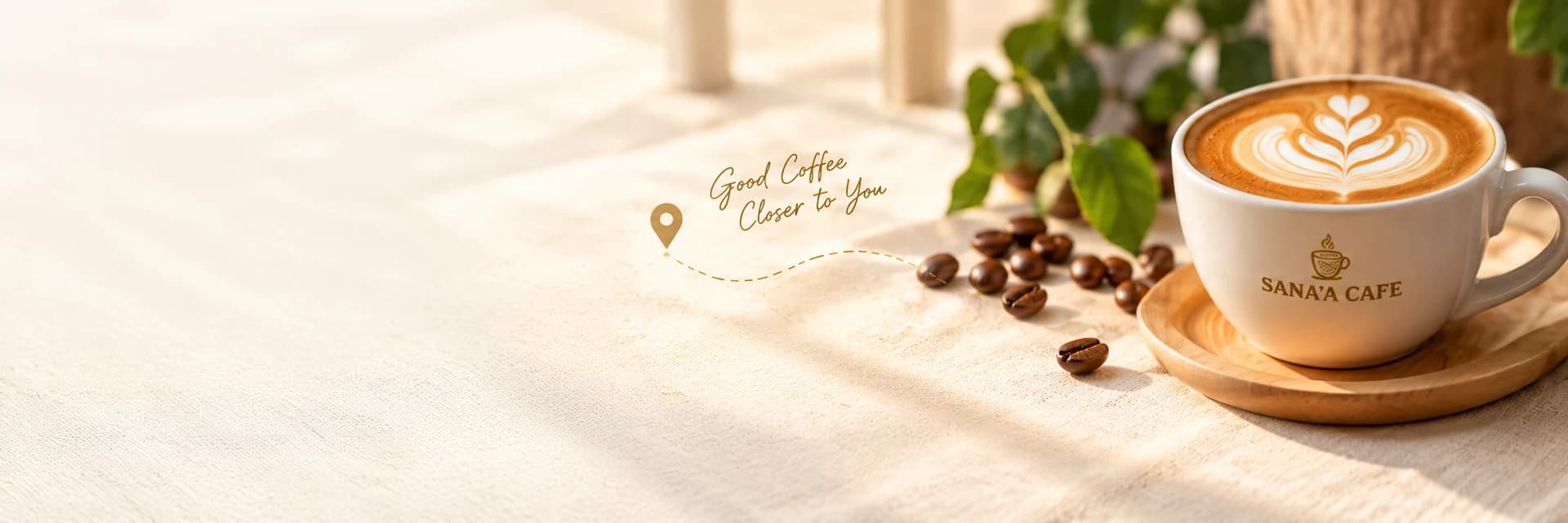 Sana'a Cafe latte with heart-shaped latte art, coffee beans, and warm sunlight